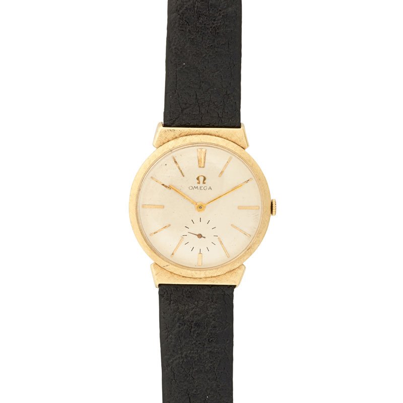 GENTLEMAN'S YELLOW GOLD GENEVE OMEGA WATCH: A round case, white dial with gold dash hours, textured gold case and lugs, on black leather strap, ca. 1953-1979. Dial marked Omega, case stamped 14k, buckle 1/20-12k. G.F. 9". 19.53 dwt. GW (include