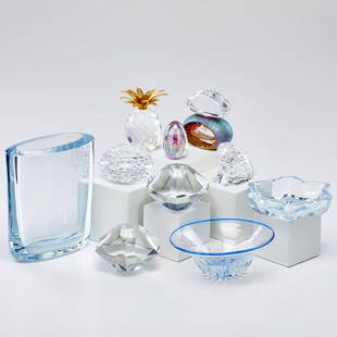 ART GLASS GROUP: Ten pieces: pair of Cartier candle holders, Swarovski "pineapple" with gilt metal leaves, Eva Englund bowl, Craig Zweifel perfume bottle, Waterford "rabbit", Georg Jensen pillow vase, ash tray and two