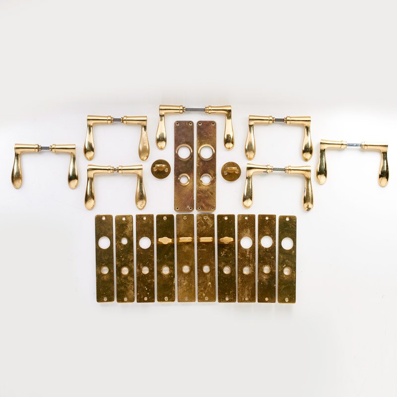 STYLE OF ARNE JACOBSEN: Set of seven brass door handles with hardware, Denmark, 20th c.; Unmarked; 4 1/2" x 2 1/2"