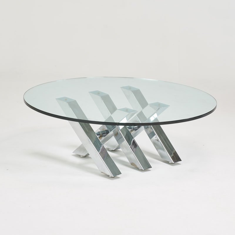 STYLE OF CY MANN: Cocktail table, USA, 1970s; Chromed steel, glass; Unmarked; 16 1/2" x 48" dia.