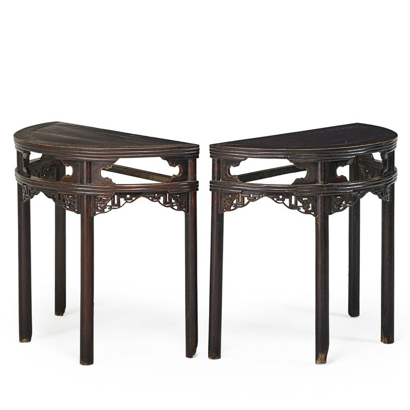 PAIR OF BROWN LACQUER DEMILUNE CONSOLE TABLES: Each with pierced apron, China, 19th c.; 34" x 37 1/2" x 18 1/2"