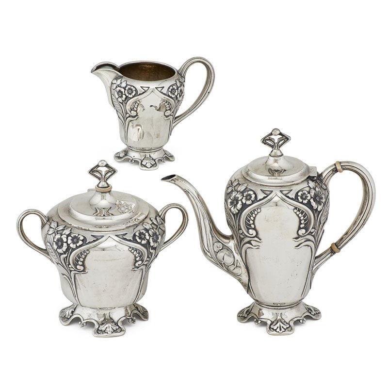RUSSIAN ART NOUVEAU SILVER TEA SET: Three: Teapot, creamer, and hinged lid sugar bowl, all with goldwash interiors, Orset Fedorovich Kurliukov, Moscow, 1899-1908; Marked; Teapot: 8 1/4"; 40.6 OT
