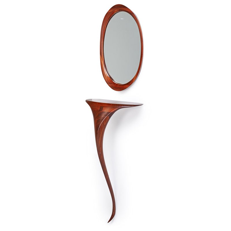 VICTOR DiNOVI: Custom-designed sculptural console table and mirror, Santa Barbara, CA, 1990; Laminated and carved wood, mirrored glass; Signed and dated; Console table: 36" x 19" x 12", mirror: 25" x 15" x 2 1/2"; P