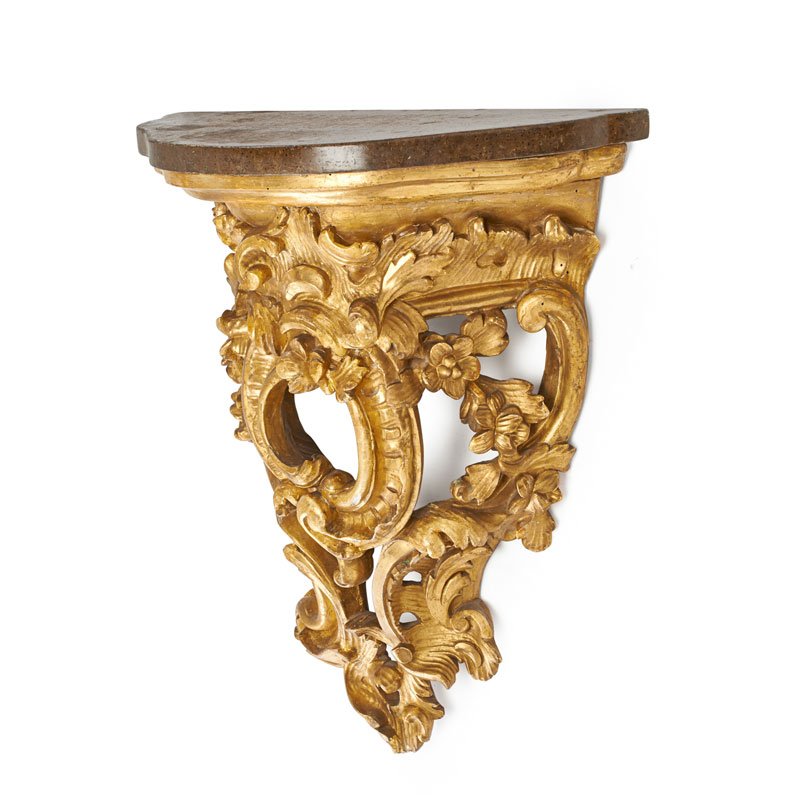 LOUIS XV STYLE GILTWOOD WALL BRACKET: Scroll and foliate decorated bracket with faux stone painted top, 19th c. 19 3/4" x 16 3/4" x 8 3/4" Provenance: Collection of Alan Olswing and Douglas Crowell