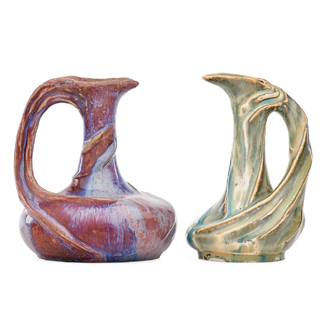 EDMOND LACHENAL; ATELIER DE GLATIGNY Two pitchers: EDMOND LACHENAL (1855 - 1930) ATELIER DE GLATIGNY Swirling stoneware and porcelain pitchers, oxblood and ivory glazes, France, ca. 1899-1900 Signed LACHENAL, stamped Glatigny mark 5 1/2" x 5", 5 1/2"