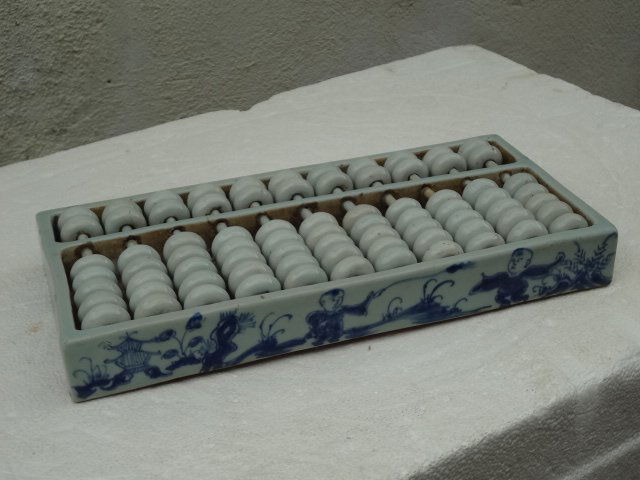 Rare Ming Dynasty First Porcelain Computer: L 12 1/4 in., W 5 3/4 in., H 1 1/2 in. This is a Ming Dynasty (16th Century) porcelain computer called abacus.It is decorated on the frames with kids playing. All the beads and rods are also made of p
