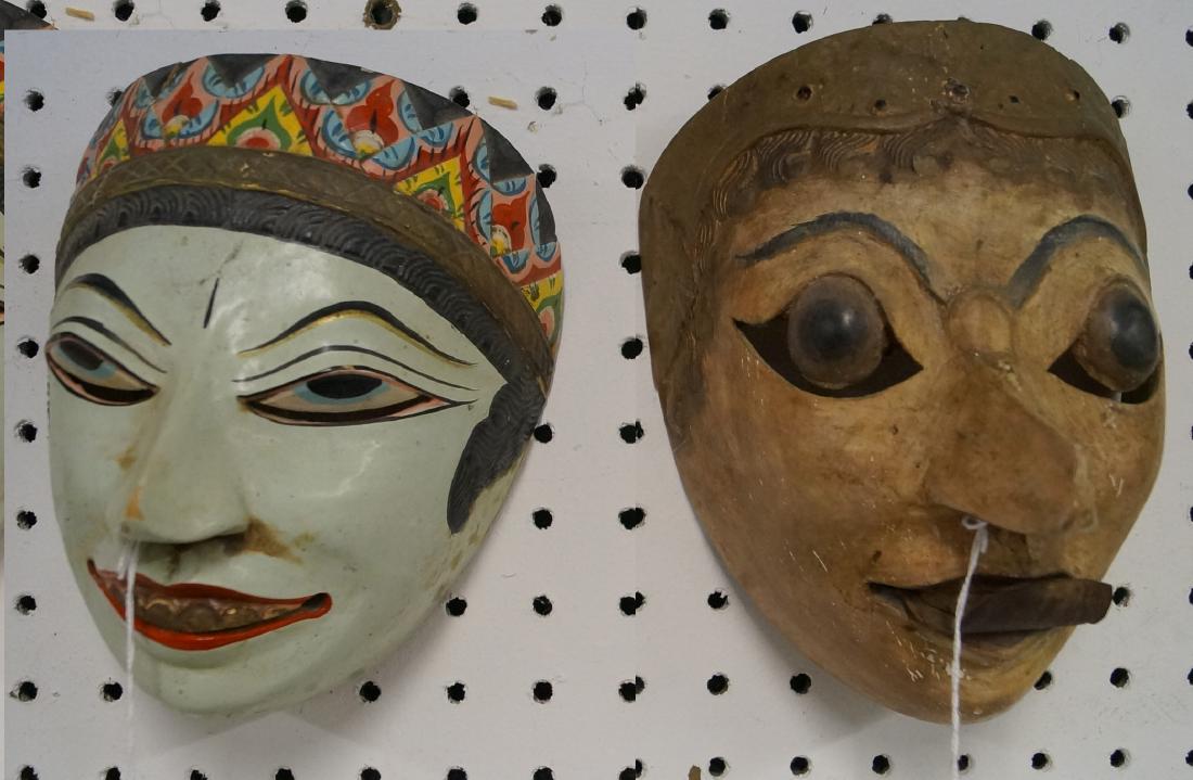 LOT (2) INDONESIAN CARVED AND PAINTED MASKS. HEIGHT 7-7: LOT (2) INDONESIAN CARVED AND PAINTED MASKS. HEIGHT 7-7 1/2"