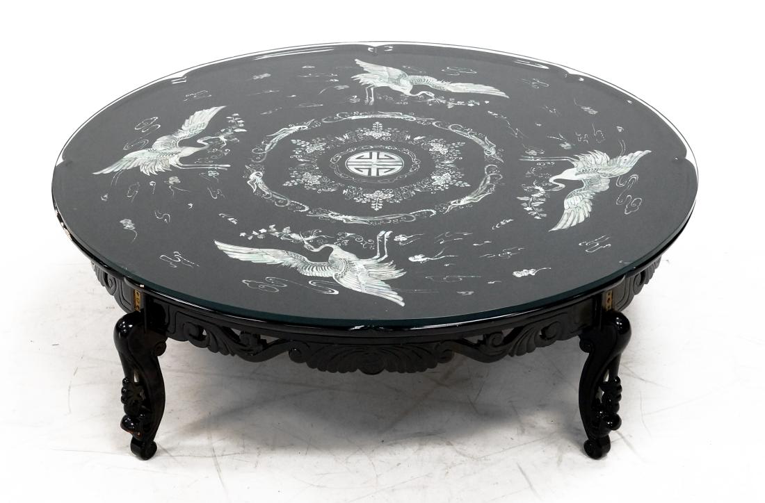 CHINESE LACQUERED AND MOTHER-OF-PEARL MOUNTED LOW TABLE: CHINESE LACQUERED AND MOTHER-OF-PEARL MOUNTED LOW TABLE WITH PLATE GLASS TOP. HEIGHT 16"; DIAMETER 42"