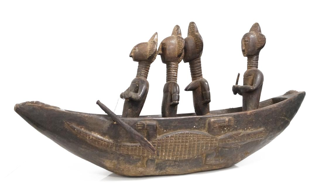 YORUBA, NIGERIA, CARVED ALTAR DEDICATION SCULPTURE OF: YORUBA, NIGERIA, CARVED ALTAR DEDICATION SCULPTURE OF 4-WARRIORS IN A CANOE. LENGTH 23 1/2"