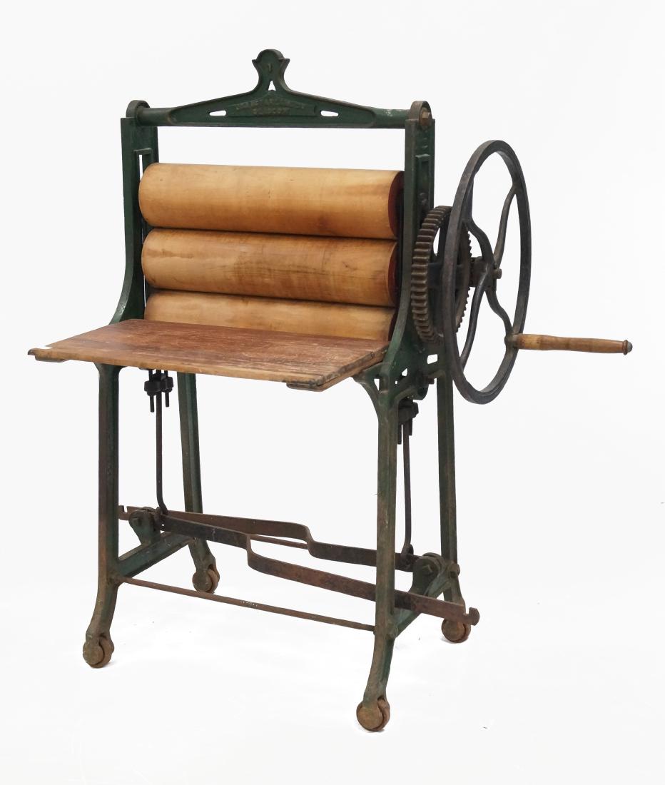 J & A MCFARLANE LTD., GLASCOW, CAST IRON/WOOD: J & A MCFARLANE LTD., GLASCOW, CAST IRON/WOOD ROLLER/WRINGER, 19TH CENTURY. HEIGHT 55"; WIDTH 33"; 24" ROLLERS