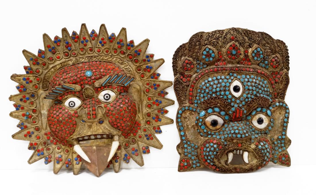 PAIR NEPALESE HAMMERED BRASS AND GLASS SET DEMON MASKS. (1 of 1)