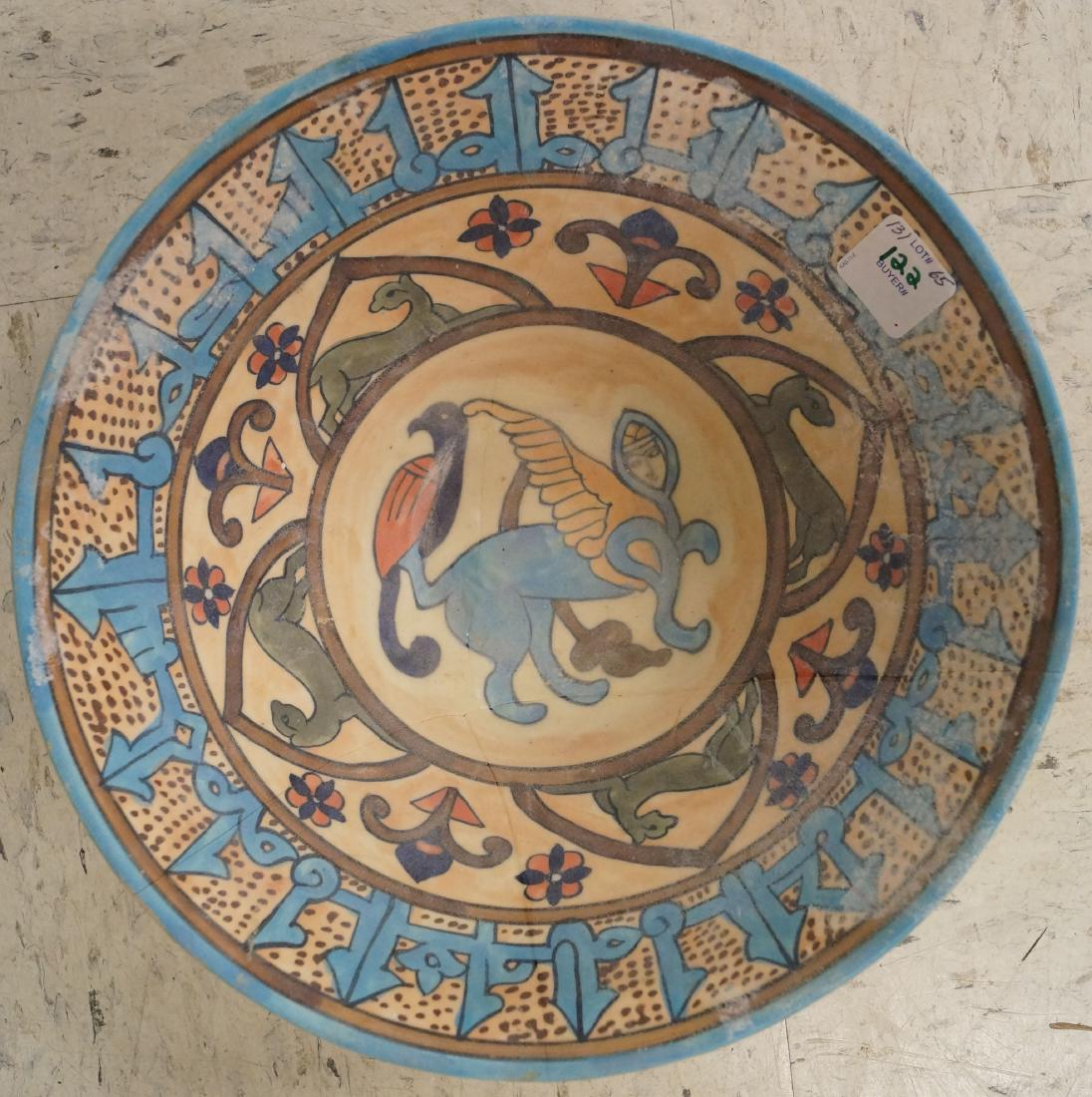 ISLAMIC DECORATED POTTERY BOWL WITH WINGED LION. HEIGHT: ISLAMIC DECORATED POTTERY BOWL WITH WINGED LION. HEIGHT 4"; DIAMETER 10 1/4" (RESTORED)