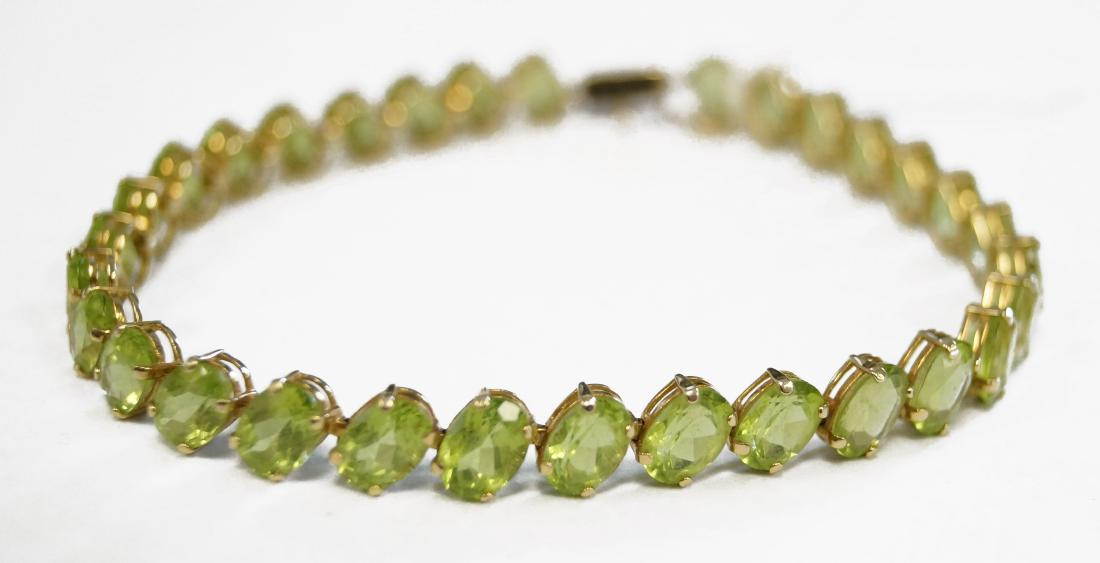 14K YELLOW GOLD, OVAL-CUT PERIDOT LINE BRACELET. LENGTH: 14K YELLOW GOLD, OVAL-CUT PERIDOT LINE BRACELET. LENGTH 8"; GROSS WEIGHT 11.4 GRAMS (31/STONES)