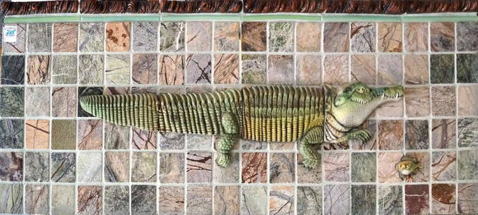 SURVING STUDIO'S HIGH RELIEF CERAMIC TILES, 4-PIECE: SURVING STUDIO'S HIGH RELIEF CERAMIC TILES, 4-PIECE ALLIGATOR APPLIQUE SET AND APPLIQUE FISH MOUNTED ON BOARD WITH MARBLE "RAINFOREST" TILES. HEIGHT 13"; LENGTH 36"