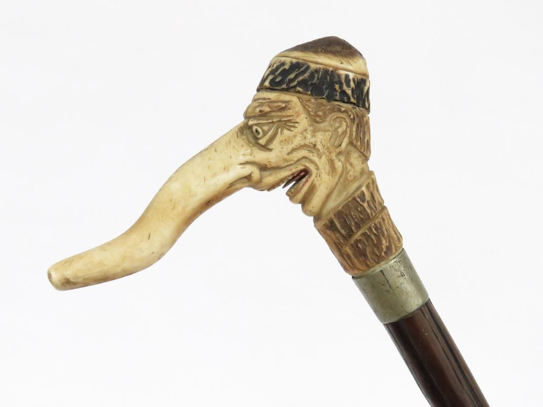 CARVED ANTLER PINOCCHIO HEAD WALKING STICK. LENGTH 36" (1 of 7)