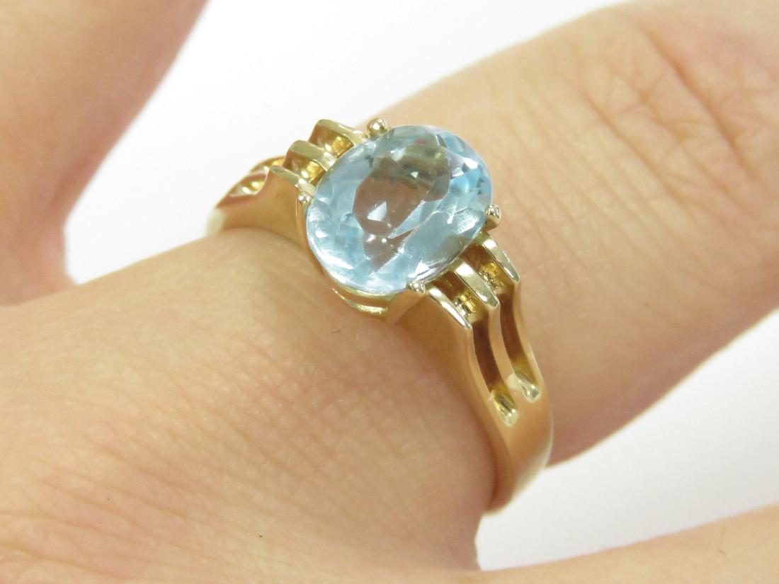 14K YELLOW GOLD AND OVAL-CUT BLUE TOPAZ RING. RING SIZE (1 of 4)