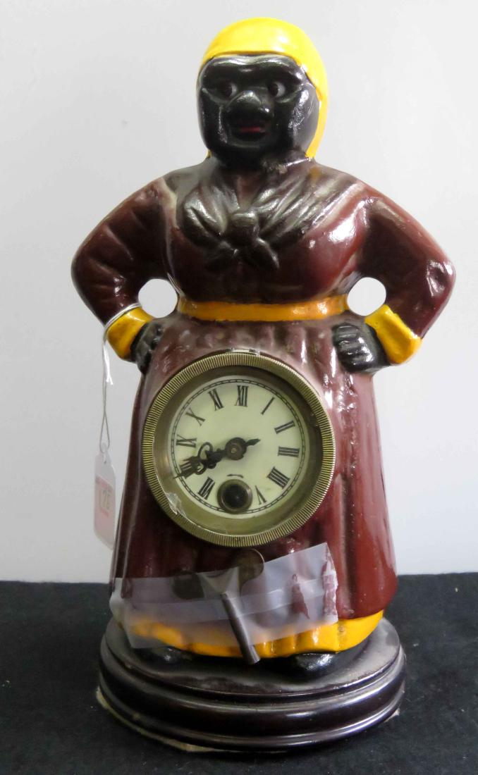BLACK AMERICANA PAINTED AND CAST IRON MAMMY CLOCK.