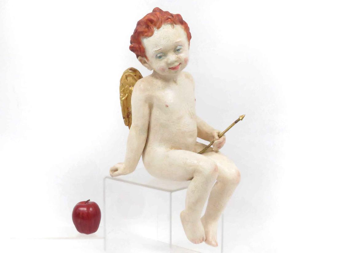 PAPIER MACHE PAINTED SEATED CUPID FIGURE WITH ARROW, (1 of 6)