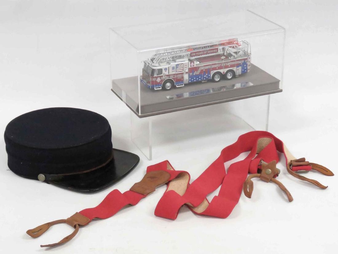 LOT (3) INCLUDING VINTAGE FIREMAN'S DRESS CAP, C.1920,: LOT (3) INCLUDING VINTAGE FIREMAN'S DRESS CAP, C.1920, PAIR RED SUSPENDERS NYFD 150 YEAR ANNIVERSARY MODEL AERIAL LADDER TRUCK, CASED, LENGTH 12"