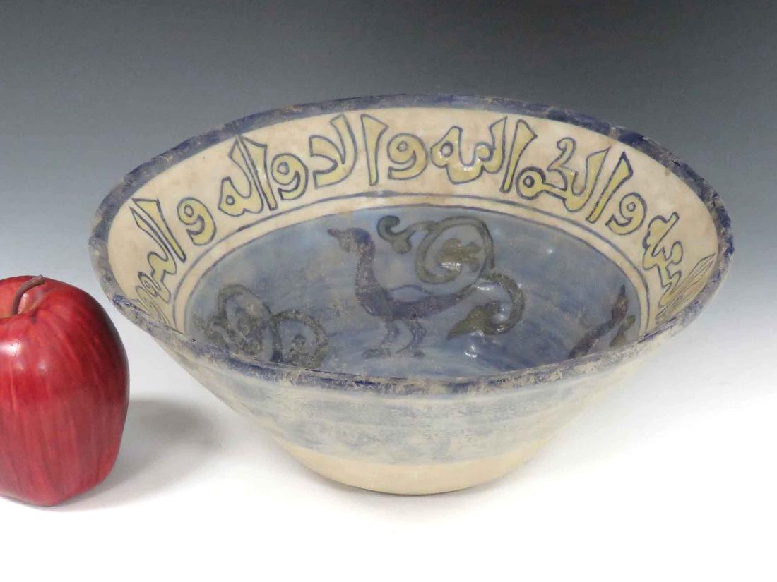 ISLAMIC DECORATED POTTERY BOWL WITH KUFIC SCRIPT.: ISLAMIC DECORATED POTTERY BOWL WITH KUFIC SCRIPT. HEIGHT 4"; DIAMETER 9 3/4"