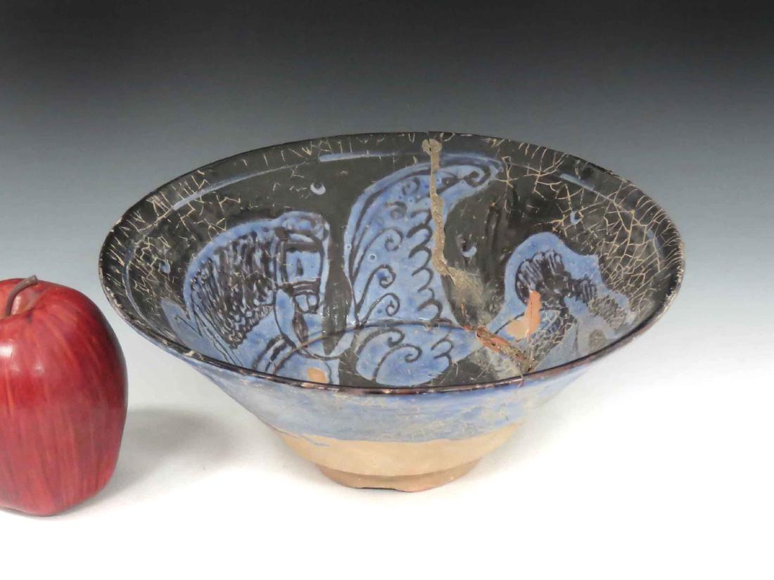 ISLAMIC DECORATED POTTERY BOWL WITH FLYING HORSE.: ISLAMIC DECORATED POTTERY BOWL WITH FLYING HORSE. HEIGHT 3 1/2"; DIAMETER 9" (REPAIRED)