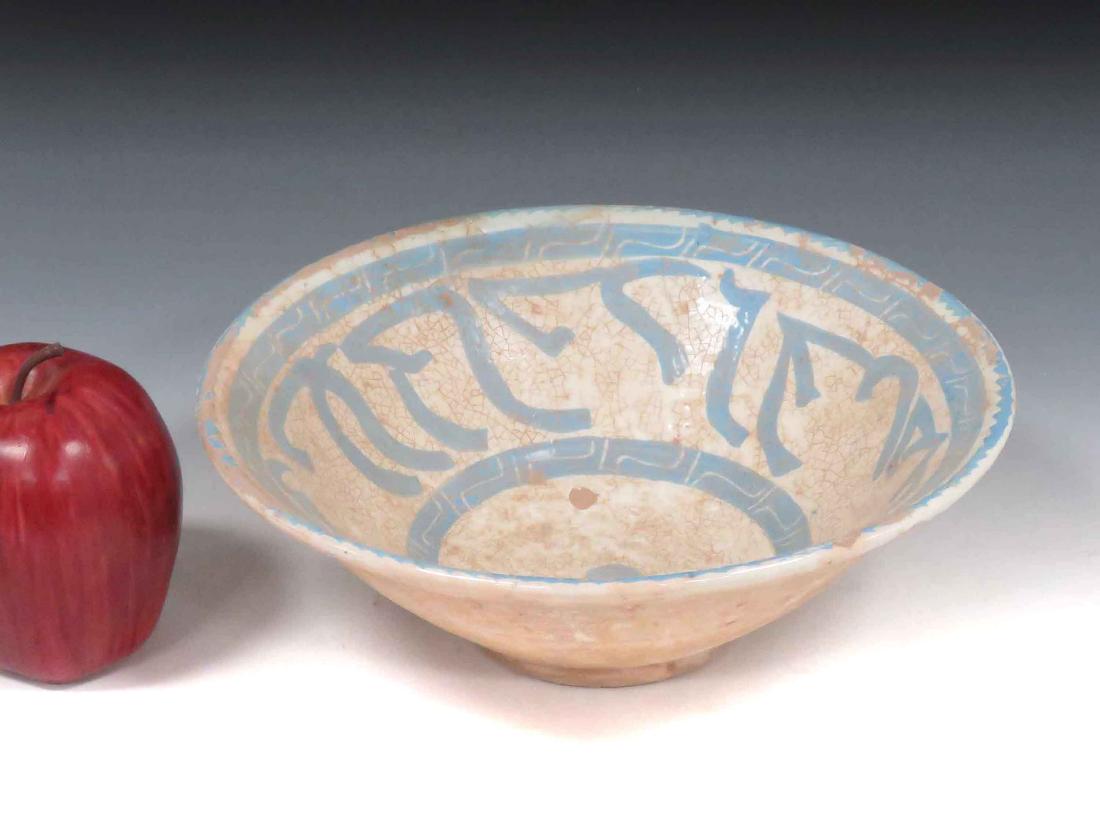 ISLAMIC DECORATED POTTERY BOWL WITH KUFIC SCRIPT.: ISLAMIC DECORATED POTTERY BOWL WITH KUFIC SCRIPT. HEIGHT 3"; DIAMETER 8 3/4"