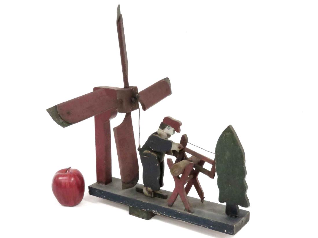 VINTAGE FOLK ART MECHANICAL WHIRL-A-GIG WOOD CUTTER.: VINTAGE FOLK ART MECHANICAL WHIRL-A-GIG WOOD CUTTER. HEIGHT 19"; LENGTH 15 1/2"