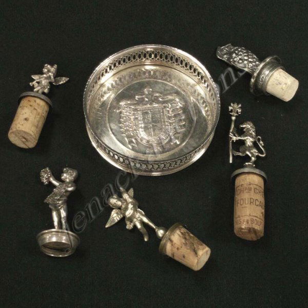 LOT (6) SILVER PLATE/BRASS INCLUDING (5) WINE CORK: LOT (6) SILVER PLATE/BRASS INCLUDING (5) WINE CORKS & (1) WINE COASTER. (HEIGHT CORK/LARGEST 5")