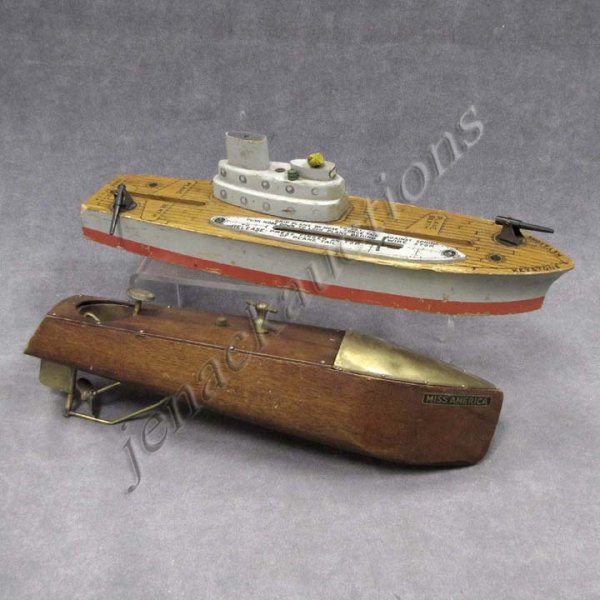 LOT (2) TOY BOATS; KEYSTONE AIRCRAFT CARRIER: LOT (2) TOY BOATS INCLUDING KEYSTONE AIRCRAFT CARRIER & MENGEL MAHOGANY & BRASS CLOCK-WORK "MISS AMERICA" RUNABOUT. LENGTH 14 1/2" & 15 3/4" (IMPERFECTIONS/LOSSES)