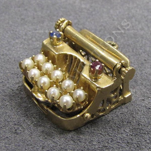 GOLD, CULTURED PEARL & GEM SET CHARM: YELLOW GOLD (TESTS 14K) CULTURED PEARL & GEM SET MECHANICAL TYPEWRITER CHARM. WIDTH 3/4"; GROSS WEIGHT 7.72 GRAMS