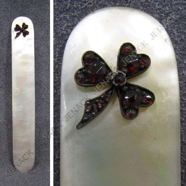 VINTAGE MOTHER-OF-PEARL PAGE TURNER: VINTAGE MOTHER-OF-PEARL PAGE TURNER WITH SILVER FRAMED 3-LEAF CLOVER SET WITH GARNETS. LENGTH 5 1/4"