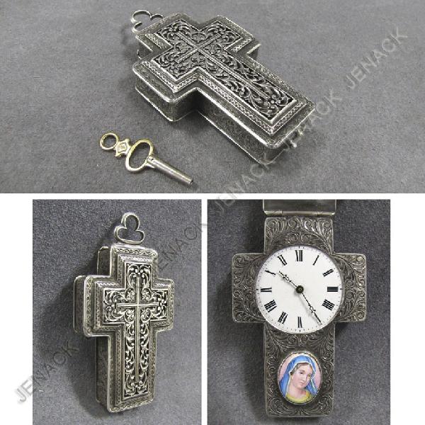 SILVER CROSS FORM CASED KEY WIND WATCH: SILVER RETICULATED CROSS FORM CASED KEY WIND WATCH WITH ENAMEL OVAL PLAQUE, MADONNA. 3 X 1 3/4"; GROSS WEIGHT 90.57 GRAMS