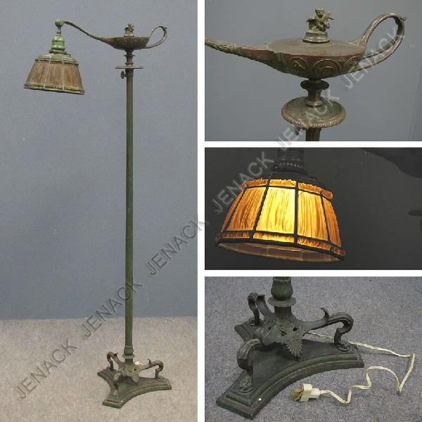 TIFFANY STUDIOS NEW YORK BRONZE ALADDIN FLOOR LAMP: TIFFANY STUDIOS NEW YORK BRONZE ALADDIN FLOOR LAMP WITH LINEN FOLD GLASS SHADE, BASE SIGNED TIFFANY STUDIOS NEW YORK #576, SHADE SIGNED TIFFANY STUDIOS NEW YORK 1938. HEIGHT 54"; SHADE/DIAMETER 8" (CR