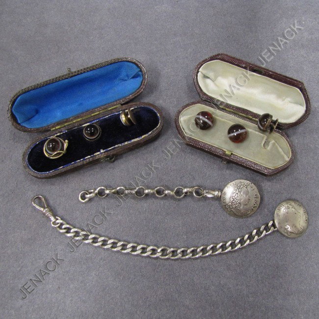 LOT (4) INCL.(2) ANTIQUE SET ONYX & GOLD STUDS: LOT (4) INCLUDING (2) ANTIQUE SET ONYX & YELLOW GOLD (TESTS 14K) STUDS WITH ORIGINAL LEATHER CASES & (2) ANTIQUE ENGLISH SILVER COINS (1700 & 1711) CONVERTED TO WATCH FOB WITH STERLING CHAINS. LENGTH 