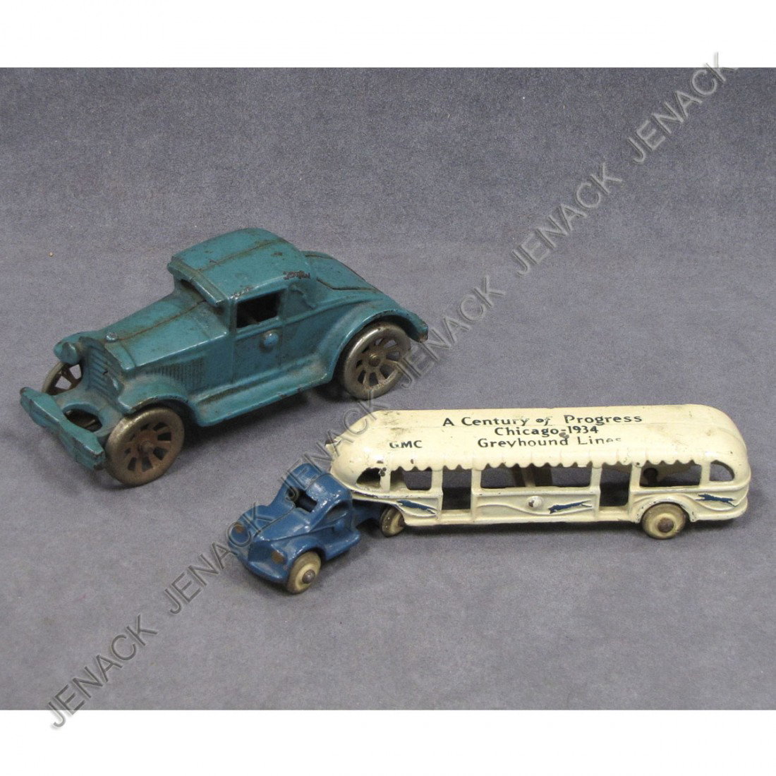 LOT (2) VINTAGE CAST IRON TOY VEHICLES: LOT (2) VINTAGE CAST IRON TOY VEHICLES INCLUDING RUMBLE-SEAT RUNABOUT AND CENTURY OF PROGRESS CHICAGO 1934 GREYHOUND LINES BUS (SCATTERED PAINT CHIPS)