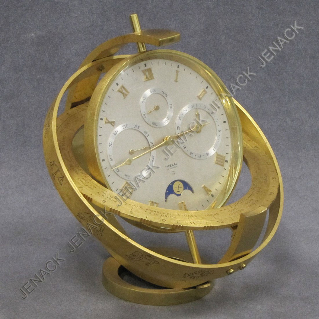IMEXAL GILT BRASS DAY AND DATE DESK CLOCK: VINTAGE IMEXAL GILT BRASS DAY AND DATE, MOON PHASE WORLD TIME DESK CLOCK. HEIGHT 8" (MECHANICAL MOVEMENT)