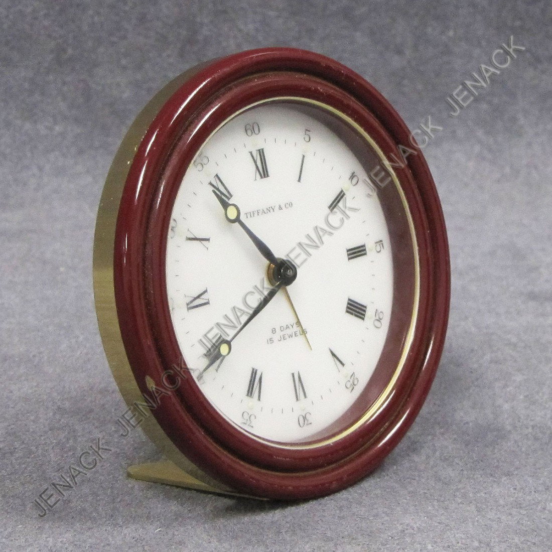 TIFFANY & CO. BRASS/ENAMEL TRAVEL/ALARM CLOCK: TIFFANY & CO. BRASS/ENAMEL 15 JEWEL 8-DAY TRAVEL/ALARM CLOCK. DIAMETER 2 7/8"