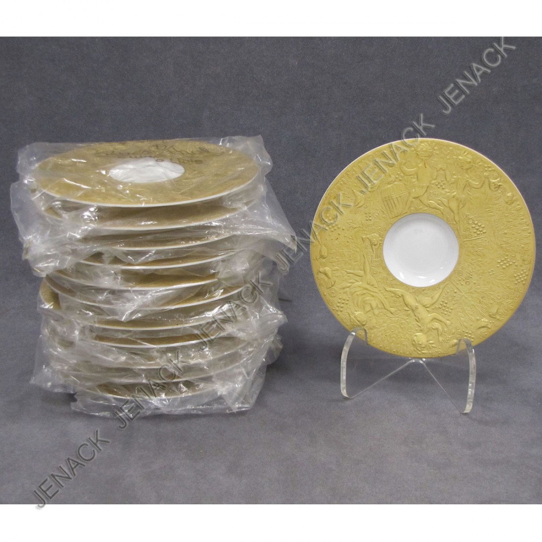 LOT (12) ROSENTHAL STUDIO LINE, BJORN WIIBLAD: LOT (12) ROSENTHAL STUDIO LINE "MAGIC FLUTE/SARASTRO" GILT DECORATED SAUCERS, SIGNED BJORN WIINBLAD. DIAMETER 6"