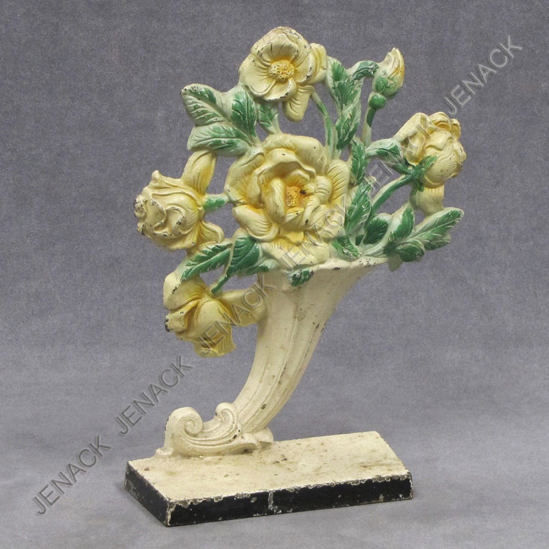 VINTAGE CAST IRON PAINTED CORNUCOPIA DOORSTOP: VINTAGE CAST IRON PAINTED CORNUCOPIA WITH YELLOW ROSES DOORSTOP. HEIGHT 10 1/4"; WIDTH 7 3/4"