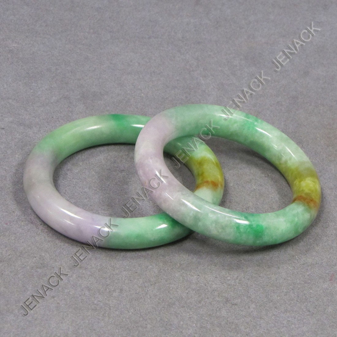 PAIR CHINESE CARVED JADE BANGLES: PAIR CHINESE CARVED JADE BANGLES. DIAMETER 3 1/4"; OPENING 2 3/8"
