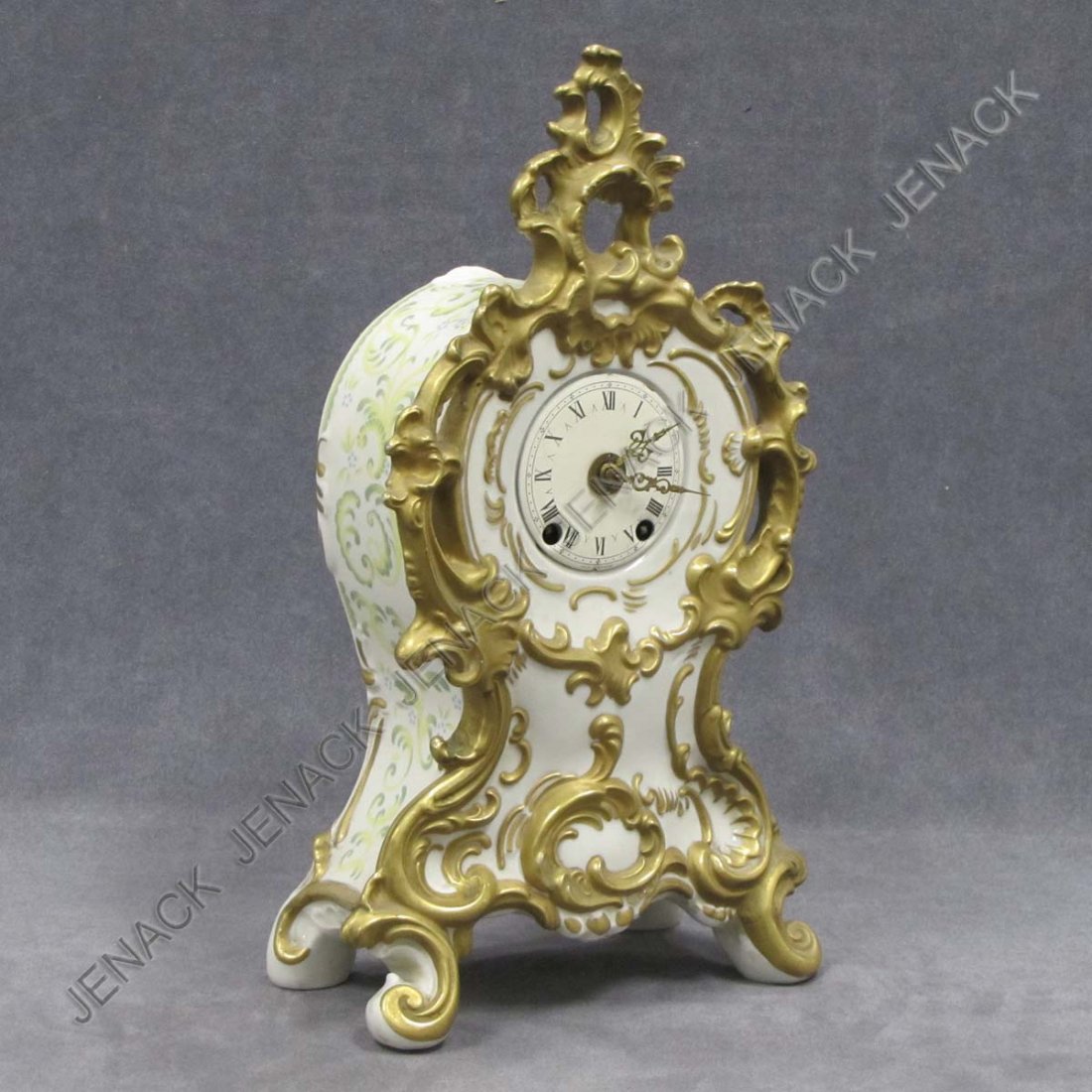 BAROQUE STYLE PARCLE GILT PORCELAIN MANTLE CLOCK: BAROQUE STYLE PARCLE GILT PORCELAIN CASED MANTLE CLOCK, GERMANY, SIGNED. HEIGHT 14"