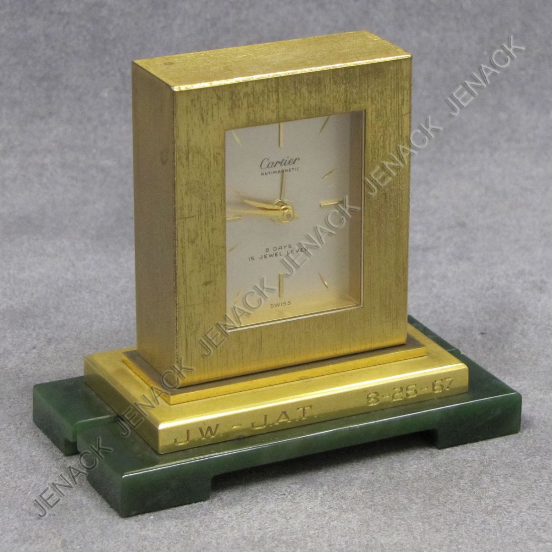 CARTIER BRASS AND JADE BASE DESK CLOCK: CARTIER BRASS AND JADE BASE 15-JEWEL LEVER & 8-DAY PRESENTATION DESK CLOCK, #487966, ENGRAVED "J.W.-J.A.T. 8-26-67". HEIGHT 3 1/4"