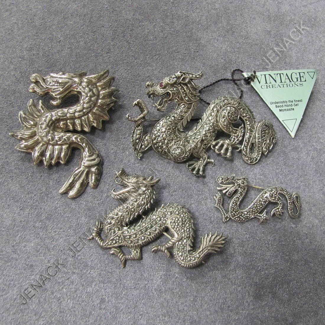 LOT (4) STERLING & MARCASITE DRAGON BROOCHES: LOT (4) STERLING & MARCASITE DRAGON BROOCHES INCLUDING VINTAGE CREATION AND MEXICAN. LENGTH 1 1/2"-2 3/4"; GROSS WEIGHT 2.01 OZT