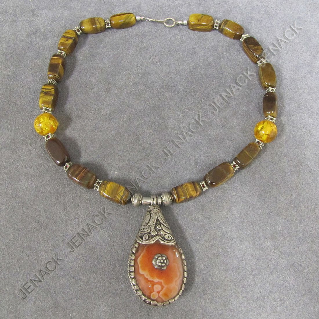 TIBETAN DESIGN STRAND TIGER EYE QUARTZ, AMBER: TIBETAN DESIGN BEADED NECKLACE STRAND WITH TIGER EYE QUARTZ, AMBER AND SILVER WITH SILVER AND AGATE PENDANT. LENGTH 18"