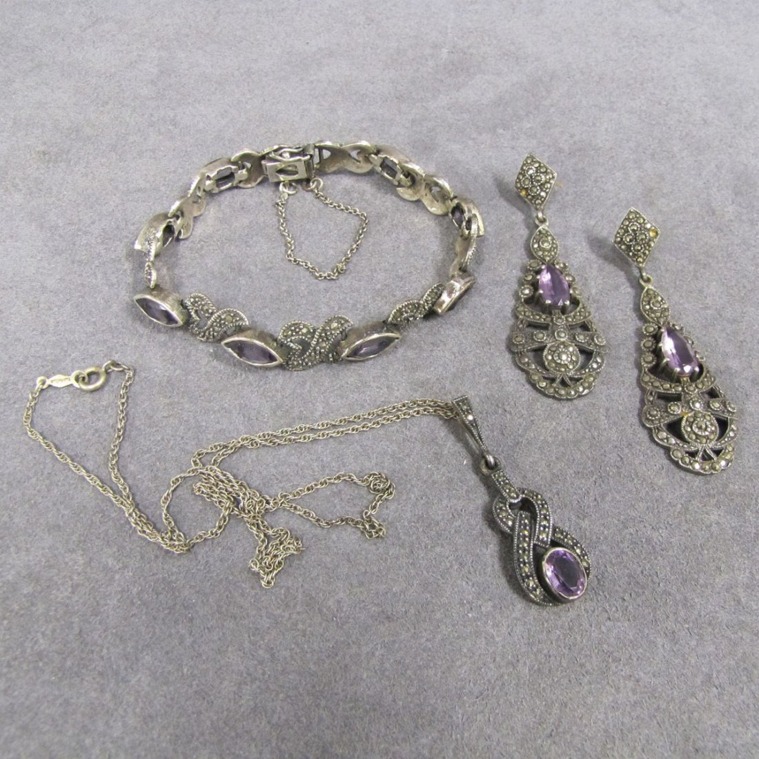 LOT (3) 925 SILVER/STERLING, MARCASITE JEWELRY: LOT (3) 925 SILVER/STERLING, MARCASITE, AND AMETHYST JEWELRY INCLUDING BRACELET, LENGTH 7 1/2"; PAIR PIERCED DROP EARRINGS, AND PENDANT WITH CHAIN, LENGTH 18"; PENDANT 1 5/8"