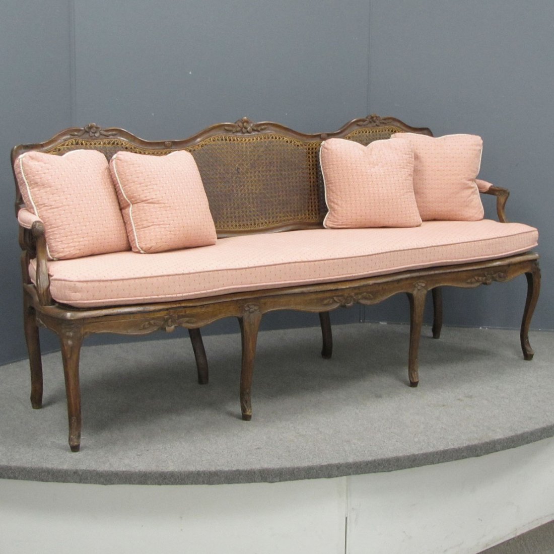 FRENCH STYLE CARVED FRUITWOOD CANED-BACK SETTEE: FRENCH STYLE CARVED FRUITWOOD CANED-BACK SETTEE. LENGTH 74"