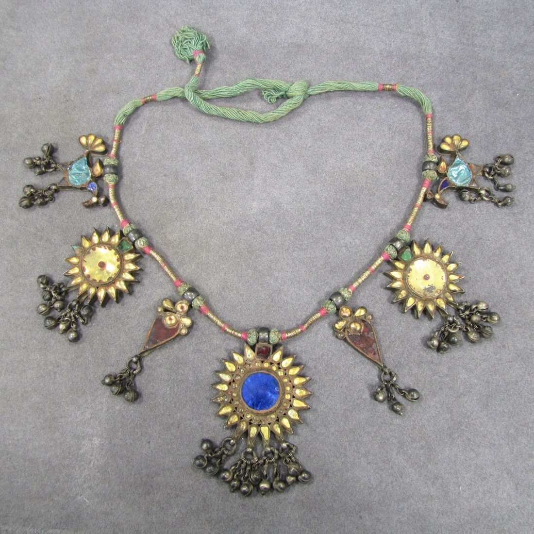 MIDDLE EASTERN SILVER AND PASTE NECKLACE: MIDDLE EASTERN SILVER AND PASTE NECKLACE WITH GILT WRAPPED CORD. LENGTH 21"