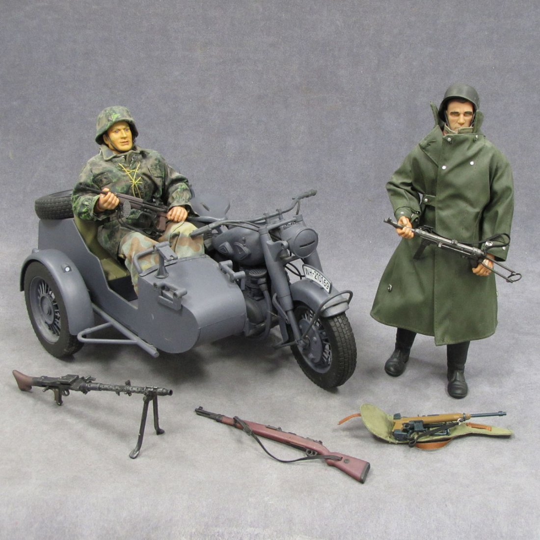 LOT INCLUDING GERMAN WWII MOTORCYCLE/SIDE CAR: LOT INCLUDING GERMAN WWII MOTORCYCLE/SIDE CAR AND (2) FIGURES WITH WEAPONS. FIGURE/HEIGHT 12"; MOTORCYCLE/LENGTH 17"
