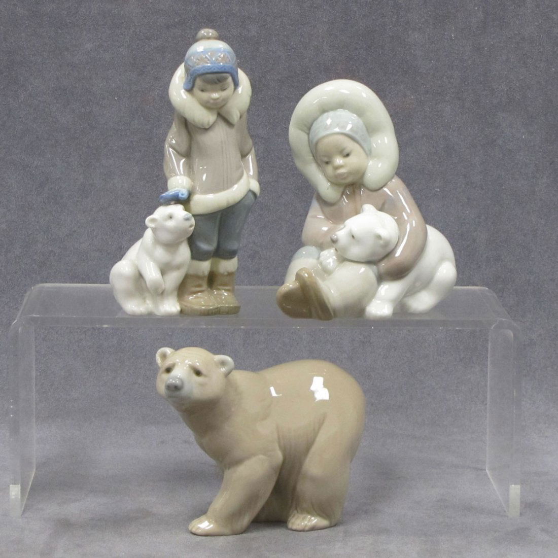 LOT (3) LLADRO PORCELAIN FIGURES: LOT (3) LLADRO PORCELAIN FIGURES INCLUDING ATTENTIVE POLAR BEAR, HEIGHT 4"; ESKIMO CHILD WITH BEAR CUB, HEIGHT 5"; CHILD WITH BEAR CUB; HEIGHT 6"