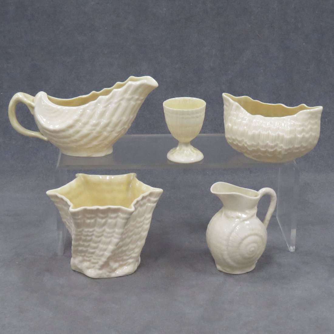 LOT (5) BELLEEK DECORATED SHELL-FORM PORCELAINS: LOT (5) BELLEEK DECORATED SHELL-FORM PORCELAINS, 20TH CENTURY (GREEN MARKS) INCLUDING EGG CUP, HEIGHT 2 1/2"; PITCHER, HEIGHT 3 1/2"; CREAMER, HEIGHT 3 1/2"; (2) VASES, HEIGHT 3 1/2" AND HEIGHT 2 1/2"